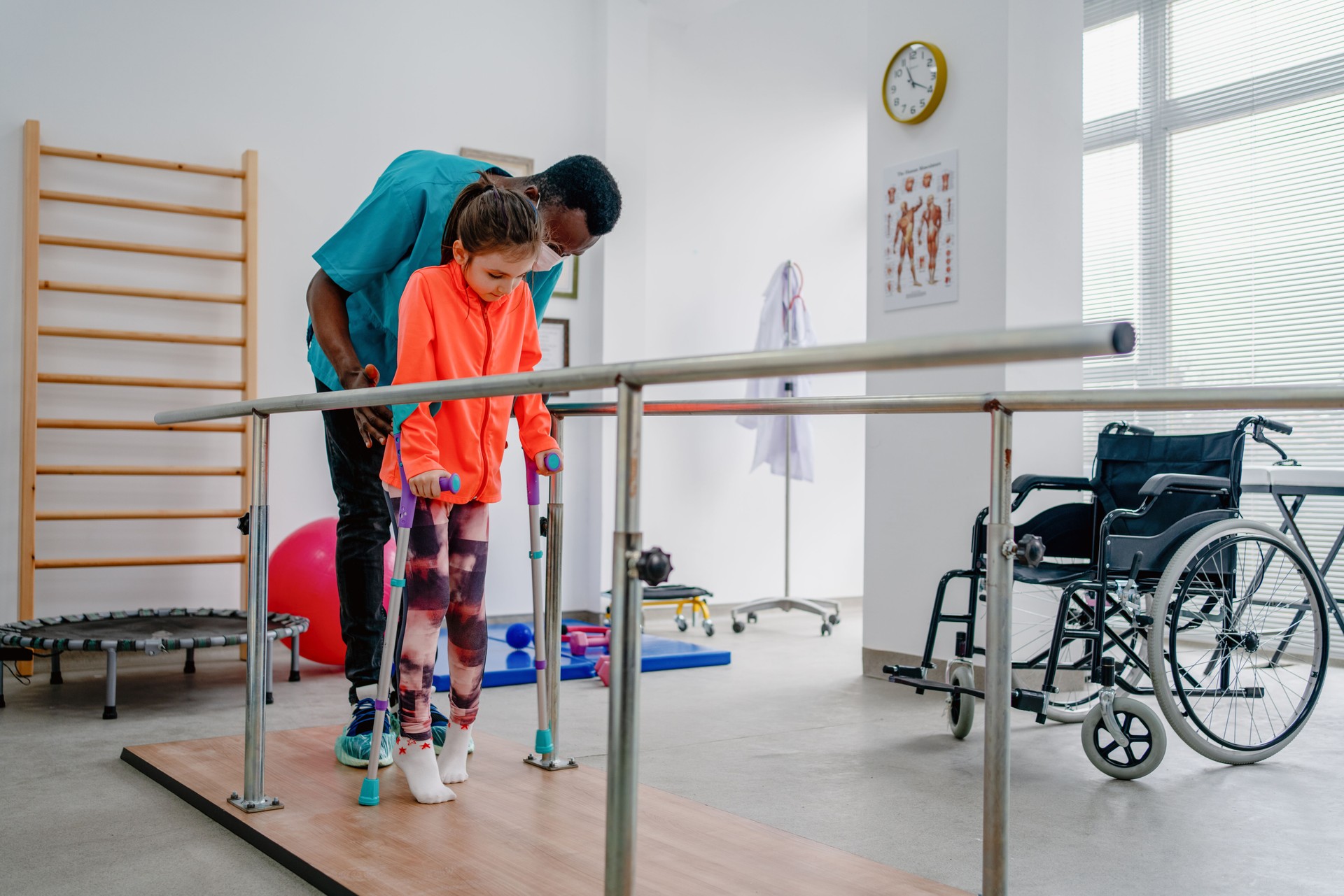 Young patient doing physiotherapy at a clinic with help of a therapist