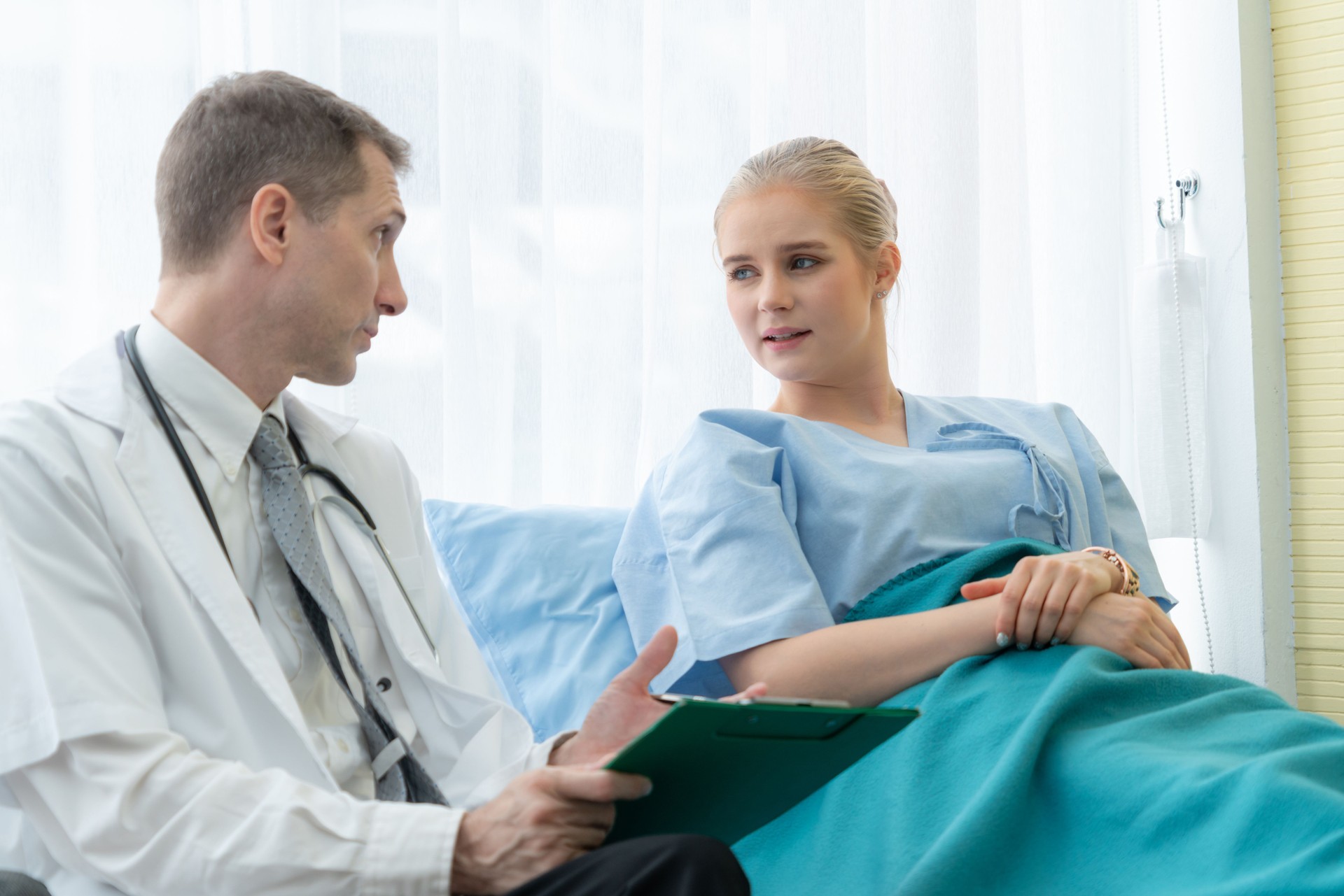 Doctor in professional uniform examining patient at hospital